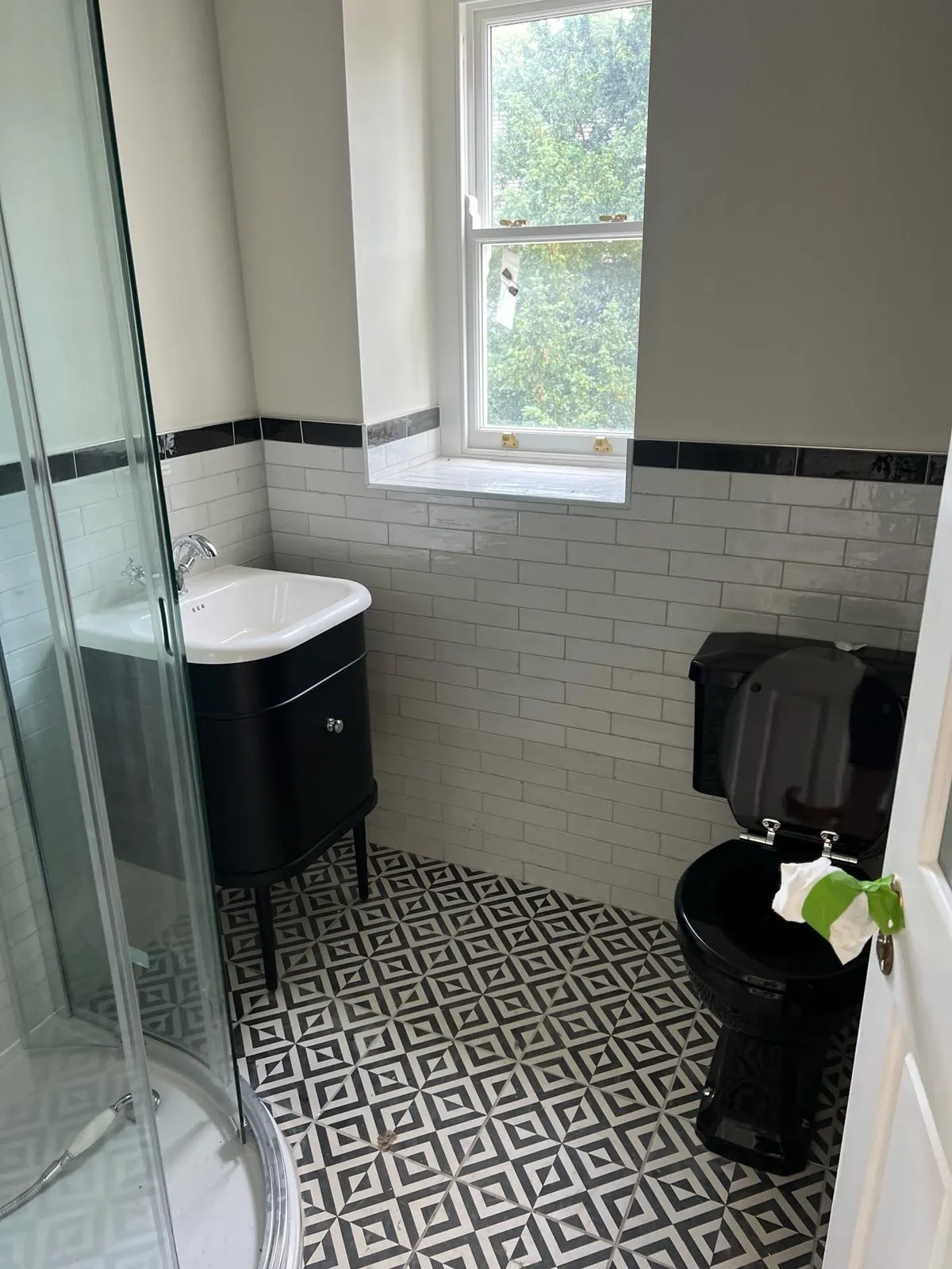 A bathroom with a toilet, sink, and shower.