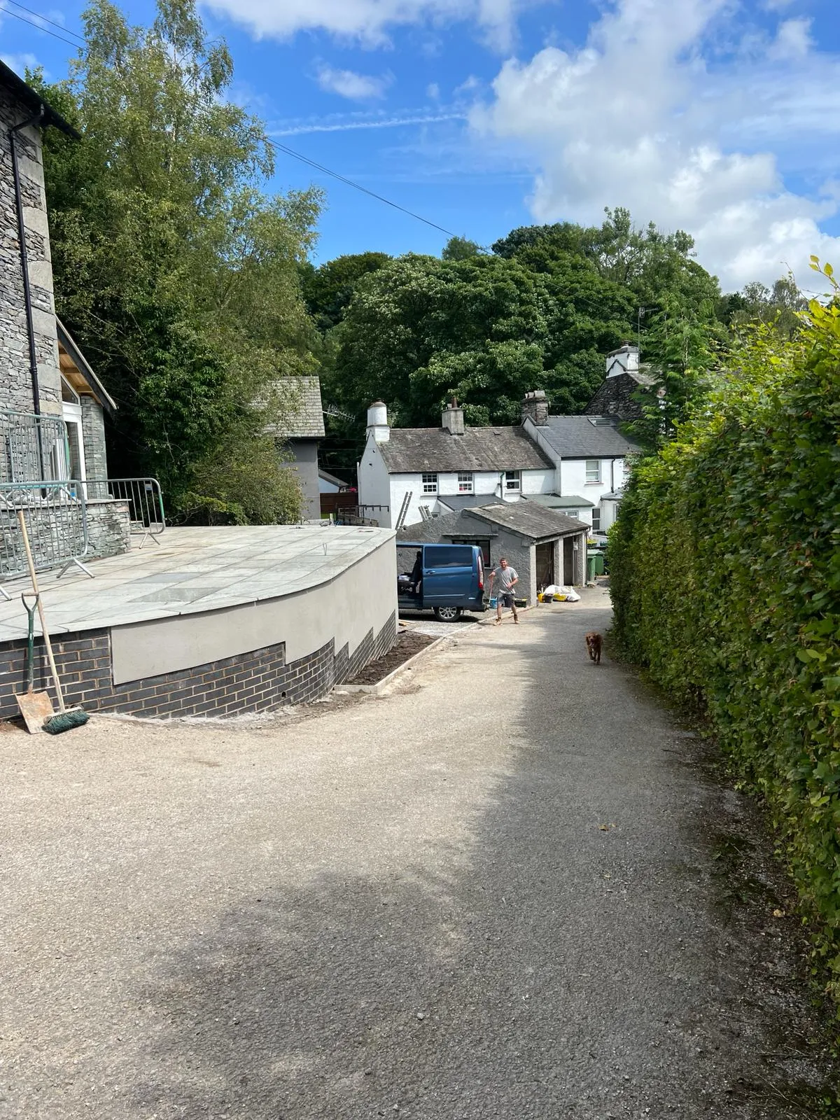 A car parked in a driveway next to a building.
