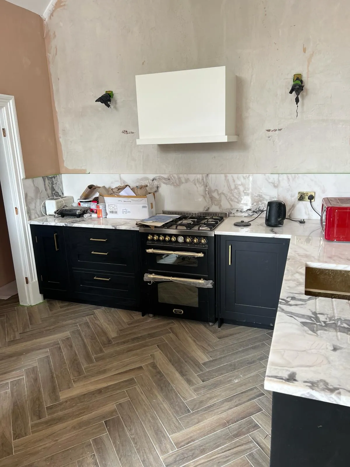A kitchen with a stove, oven, and cabinets.