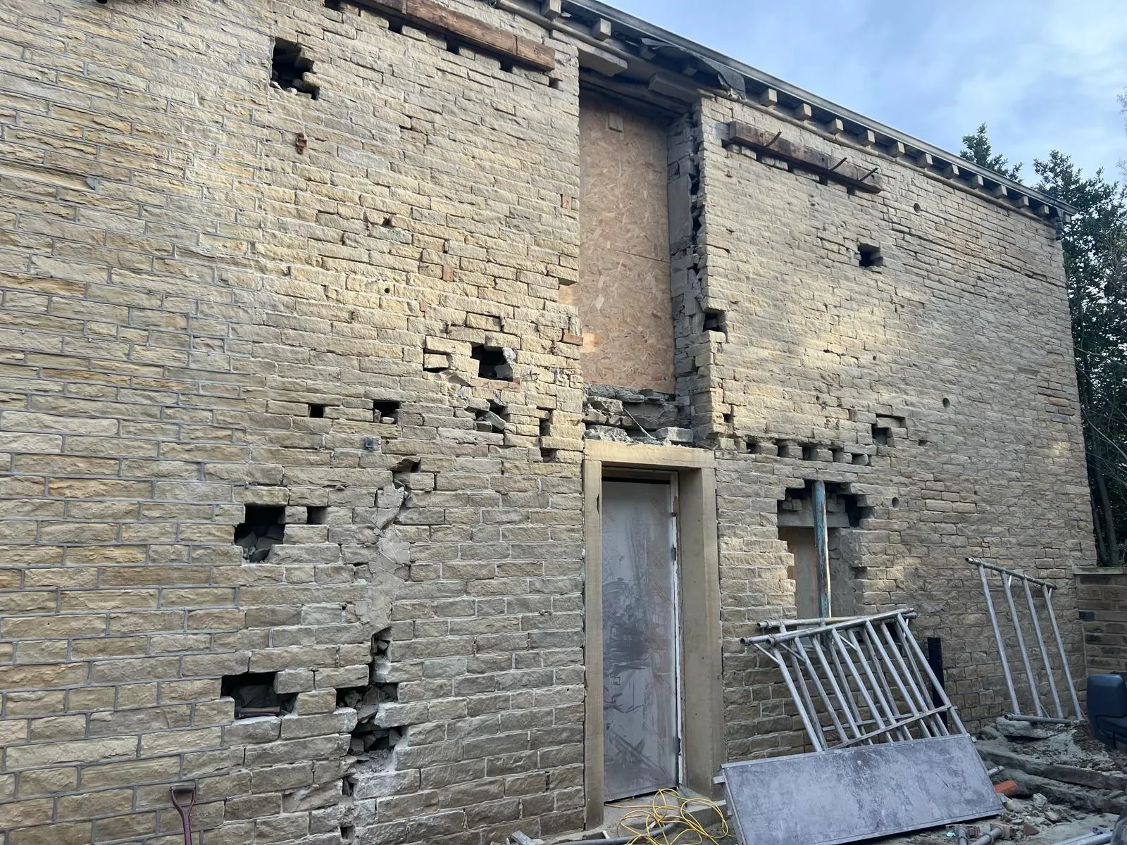 A brick building with a door and windows.