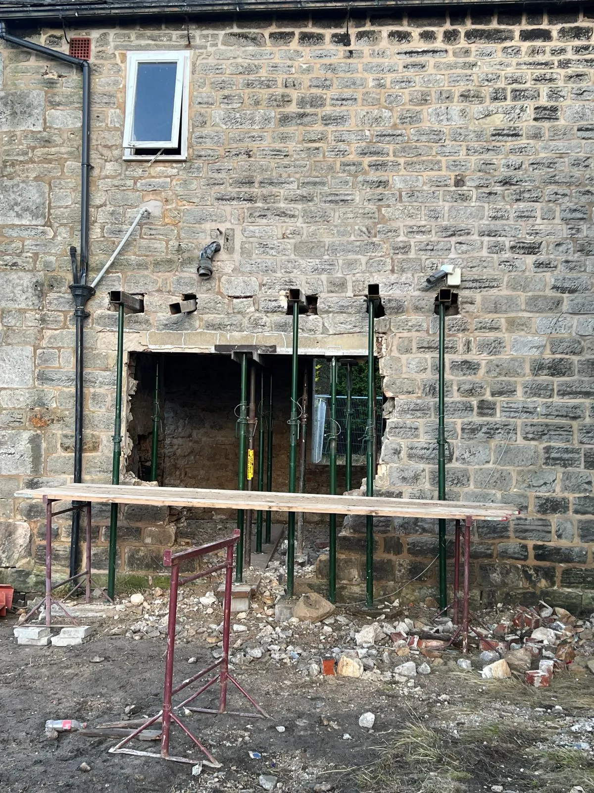 A building that has a wooden bench in front of it.