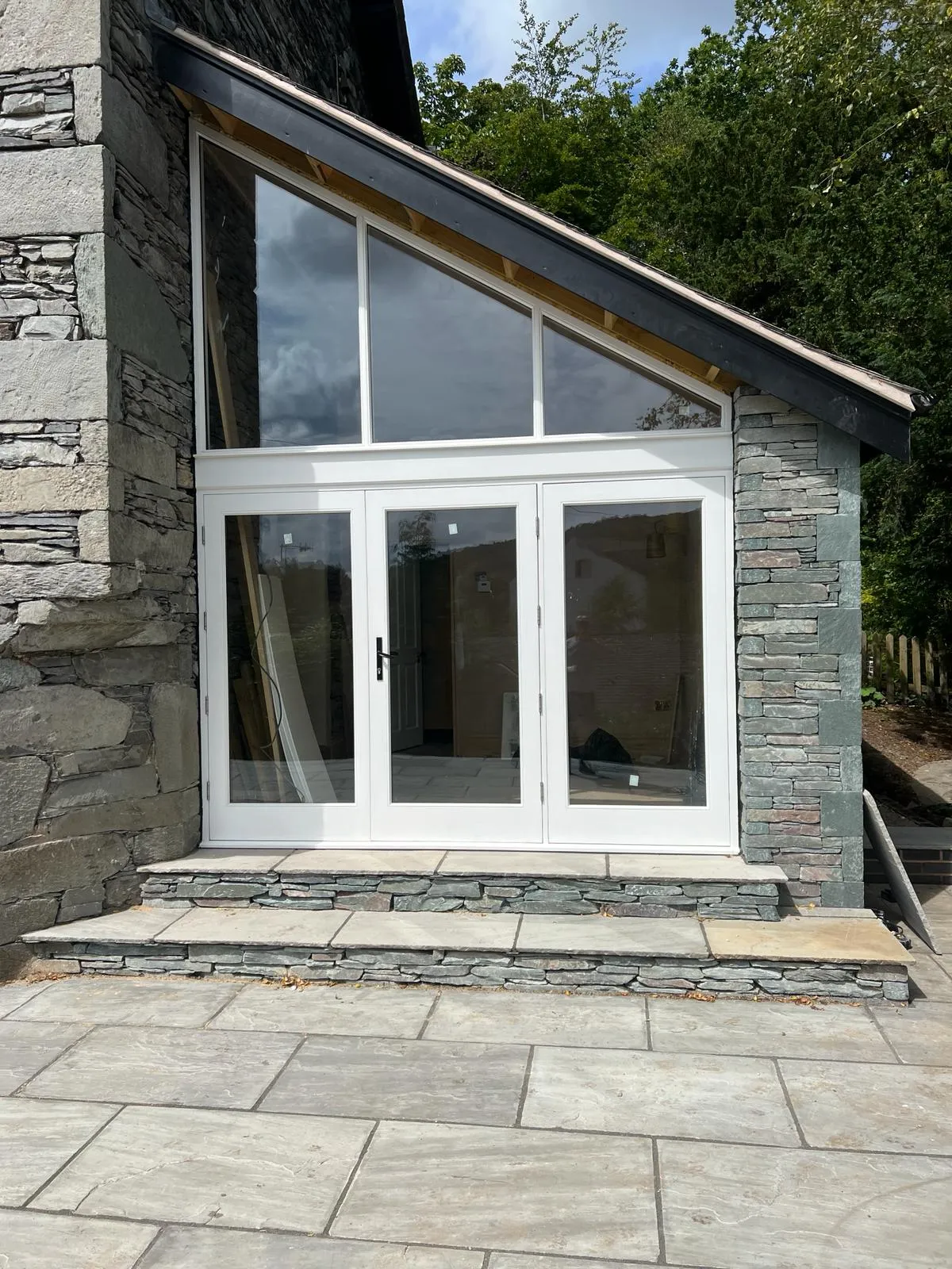A house with a large white door and windows.