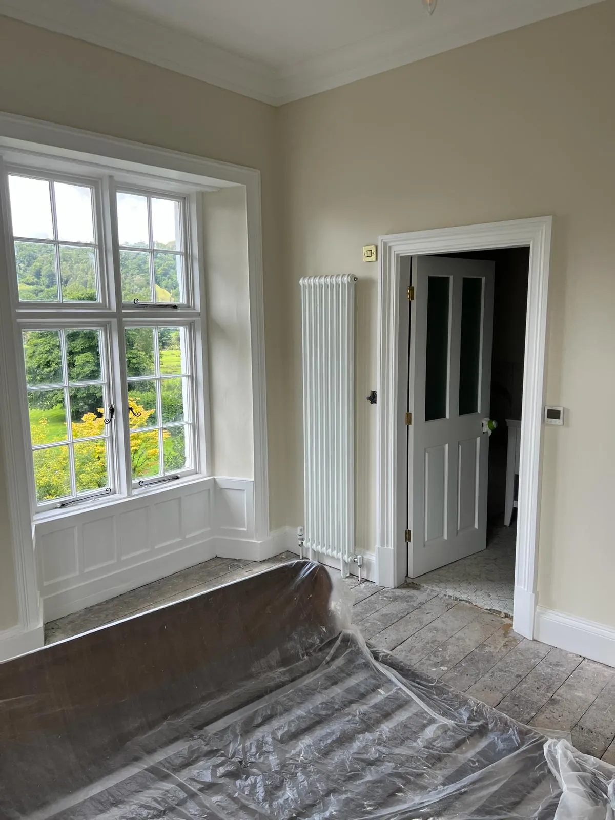 An empty room with a sheet covering the floor.